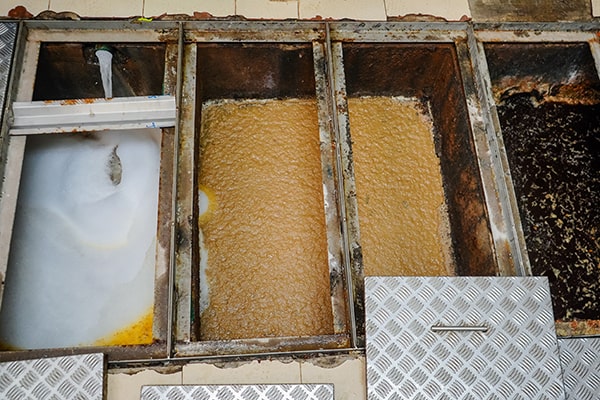 foul odors, slow draining sinks, and gurgling noises can all indicate a need for grease trap maintenance